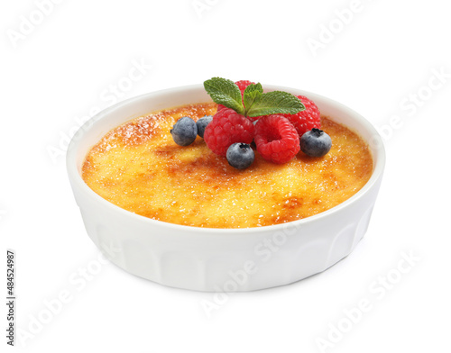 Delicious creme brulee with fresh berries isolated on white photo