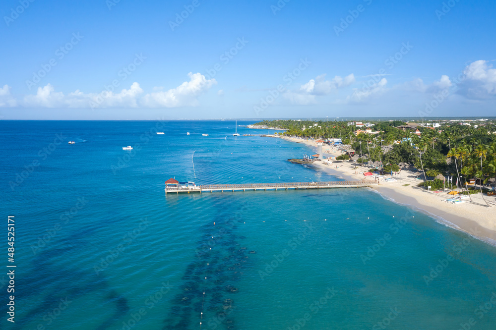 Dominicus beach at Bayahibe with Caribbean sea sandy seashore, lighthouse and pier. Aerial view