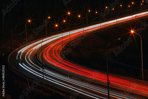 Car traffic on a long exposure, road photography at night, horizontal background for the website and publications in social networks