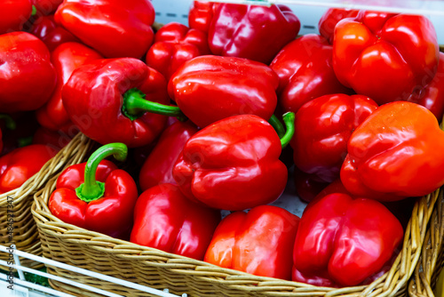 Many of red bell pepper on the counter in the grocery store. Close-up image