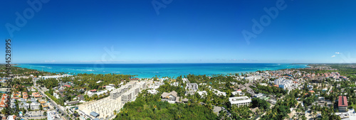 Caribbean beach of Atlantic ocean with luxury resorts, palm trees and turquoise water. travel destination. Aerial panorama view