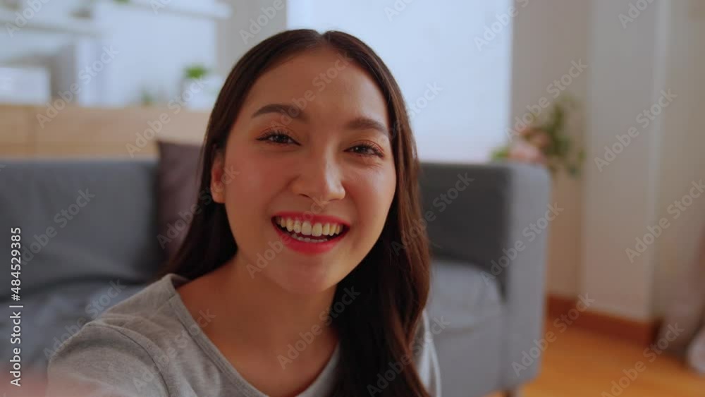 Happy beautiful asian gen z teen girl smiling face waving hand talking to video call with family at home talking chatting by virtual video call zoom app online video call meeting. Web Camera view. Happy beautiful asian gen z teen girl smiling face waving hand talking to video call with family at home talking chatting by virtual video call zoom app online video call meeting. Web Camera view.