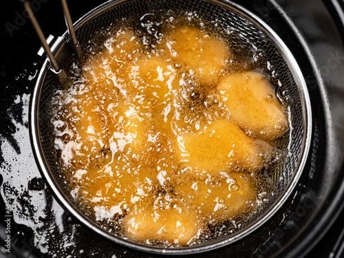 Cooking tempura chicken nuggets in deep fryer