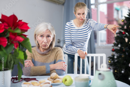 Domestic quarrel between an elderly mother and an adult daughter on Christmas holidays © JackF