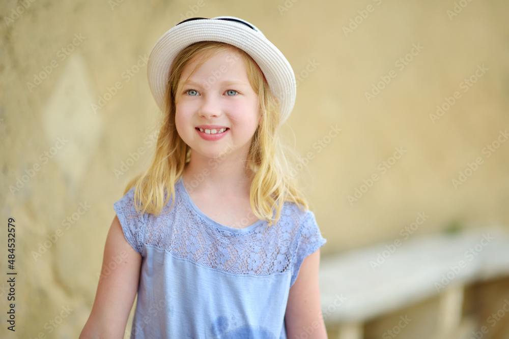 Cute young tourist girl exploring Sorano, an ancient medieval hill town hanging from a tuff stone over the Lente River. Etruscan heritage. Cute young tourist girl exploring Sorano, an ancient medieval hill town hanging from a tuff stone over the Lente River. Etruscan heritage.