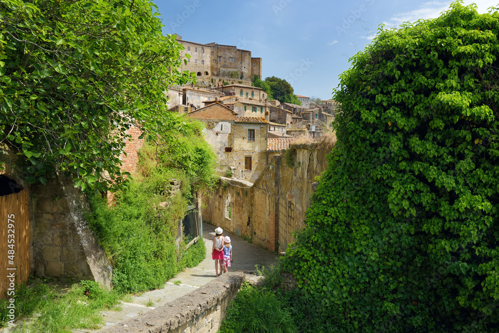 Fototapeta premium The narrow streets of Sorano, an ancient medieval hill town hanging from a tuff stone over the Lente River. Etruscan heritage.
