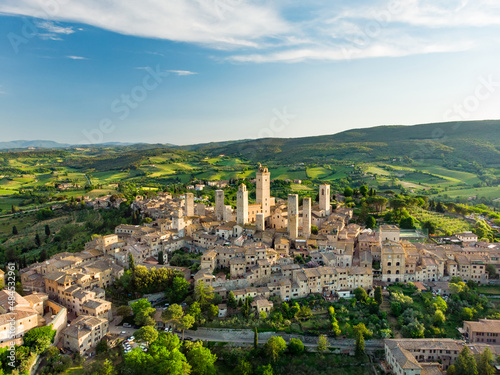 Aerial view of famous medieval San Gimignano hill town with its skyline of medieval towers, including the stone Torre Grossa. UNESCO World Heritage Site.