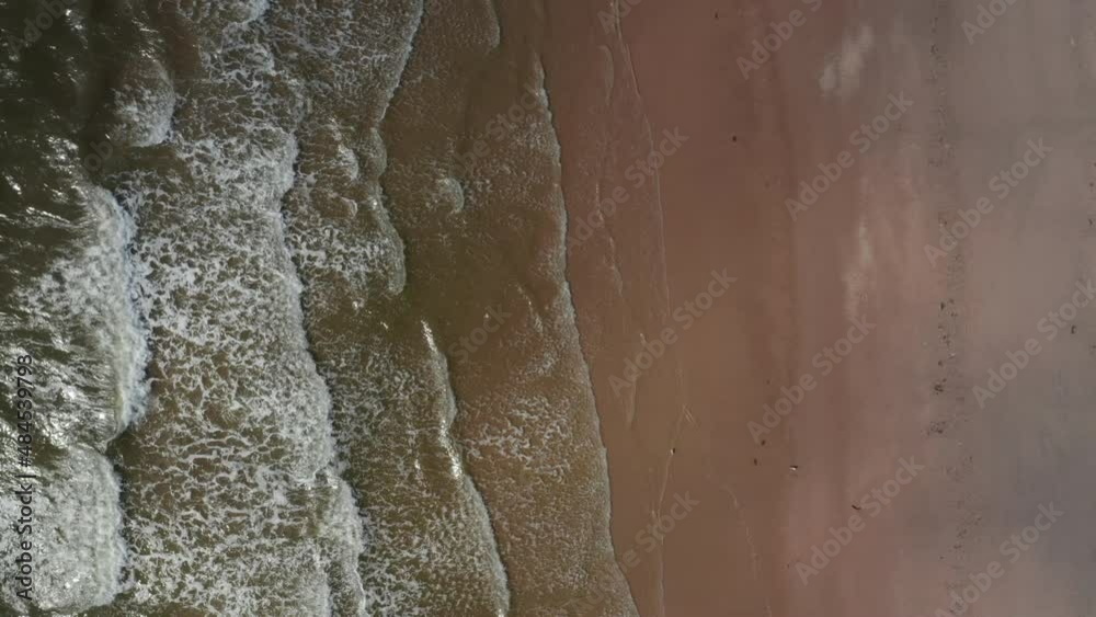 Aerial birds eye overhead top down ascending view of waves washing sand beach on North sea coast. Denmark Aerial birds eye overhead top down ascending view of waves washing sand beach on North sea coast. Denmark
