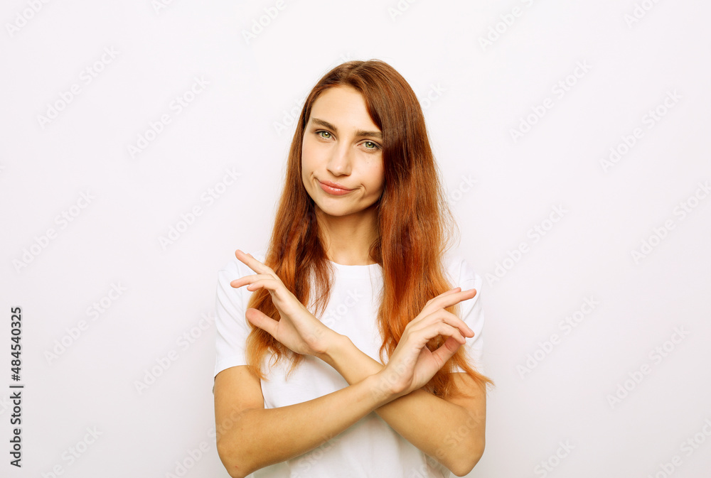 Calm woman in white t-shirt showing crossed hands gesture while looking at the camera Calm woman in white t-shirt showing crossed hands gesture while looking at the camera