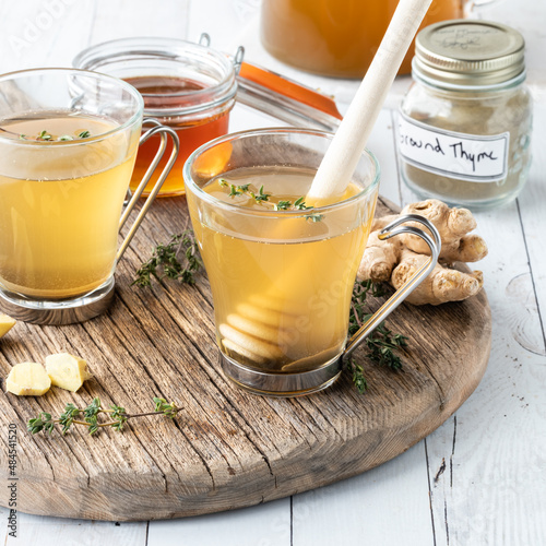 Medicinal tea using ginger, thyme and honey, ready for drinking. photo