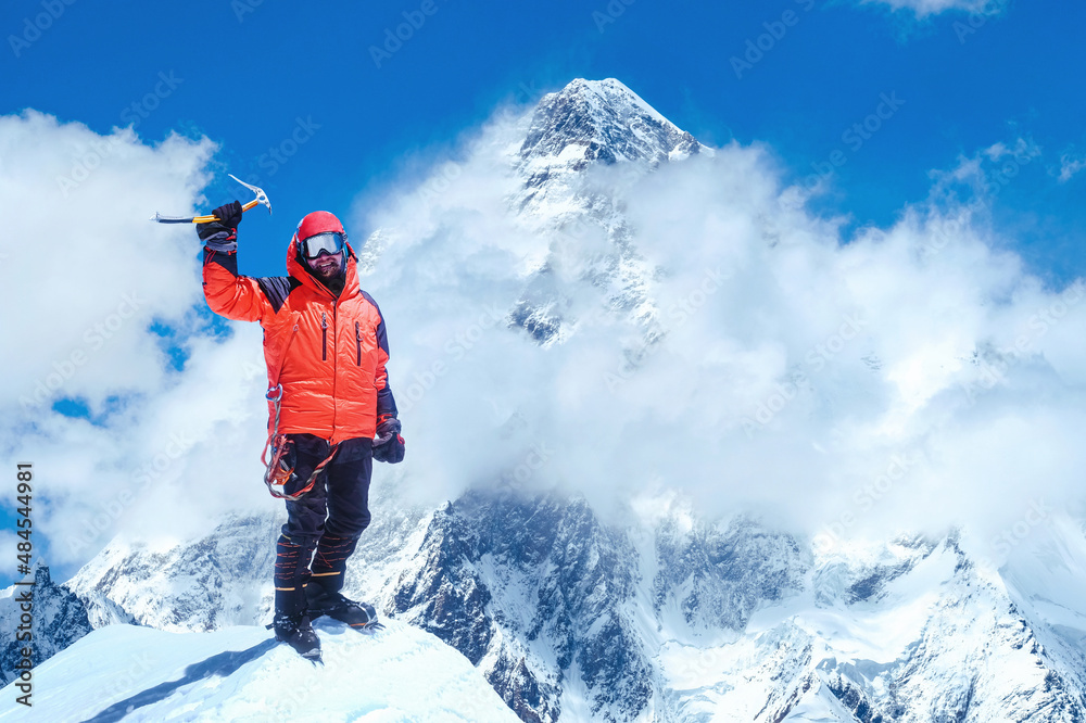 Climber reaches the summit of mountain peak, Nepal.