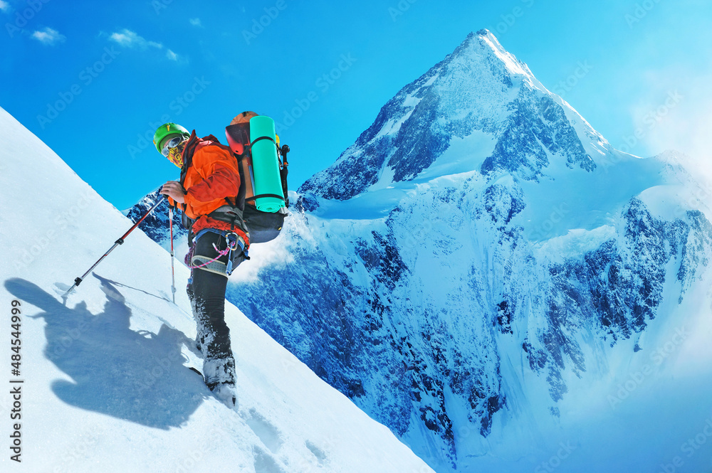 Mountaineer reaches the top of a snowy mountain peak Everest. Extreme sport concept. Nepal mountains.