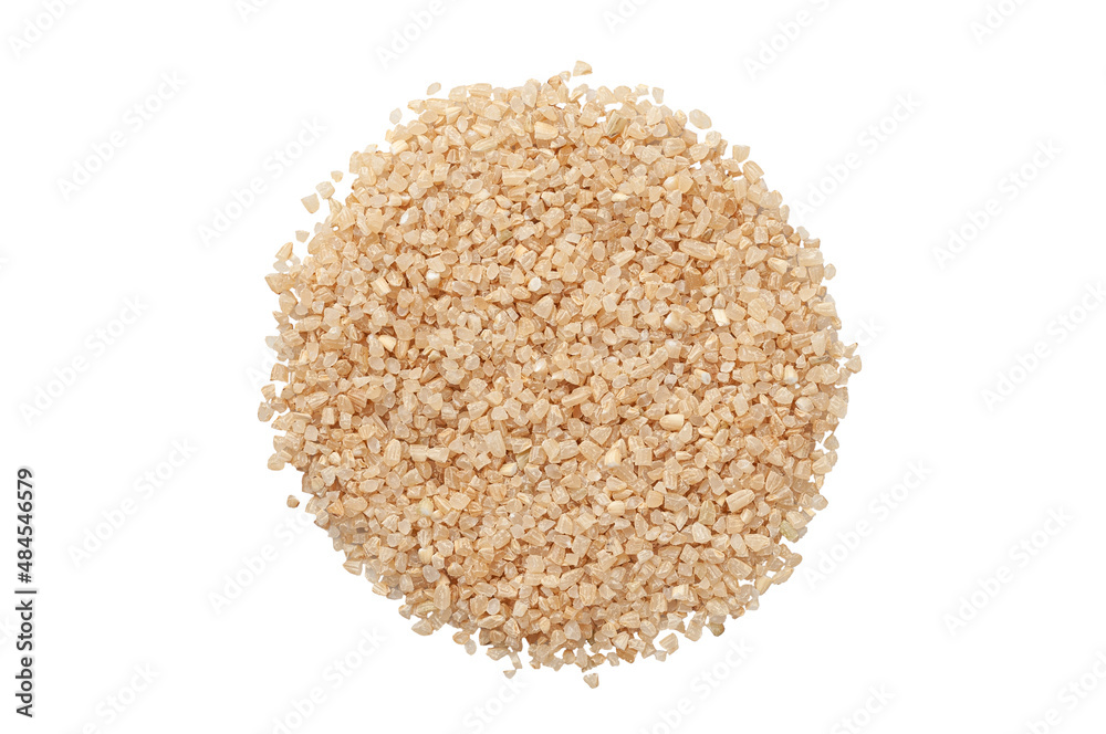Seeds of brown crushed rice. View from above. White background. Isolated. Seeds of brown crushed rice. View from above. White background. Isolated.
