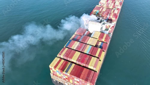 Stern of large cargo ship with Smoke exhaust gas emissions from cargo lagre ship ,Marine diesel enginse exhaust gas from combustion. photo