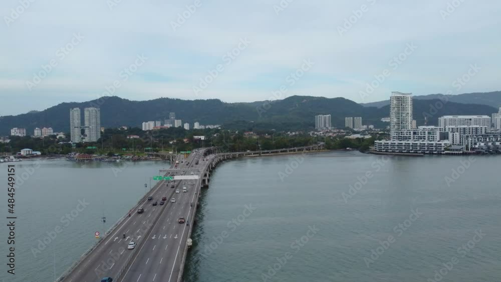 Aerial drone shot of the first Penang Bridge, view facing the island. The bridge connects Prai on the mainland of Malaysia, crossing the Penang Strait. Aerial drone shot of the first Penang Bridge, view facing the island. The bridge connects Prai on the mainland of Malaysia, crossing the Penang Strait.