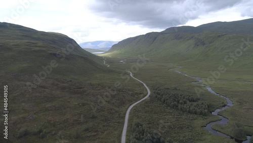 Aerial push in over the river Ossian heading North towards Loch Ghuilbinn, on a cloudy and moody day photo