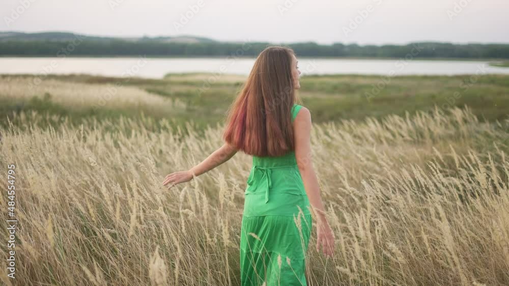 free girl walk fun across field in the park. free dream concept. girl whirls hands to sides walk across the field. lifestyle happy free girl walking in park nature land free girl walk fun across field in the park. free dream concept. girl whirls hands to sides walk across the field. lifestyle happy free girl walking in park nature land
