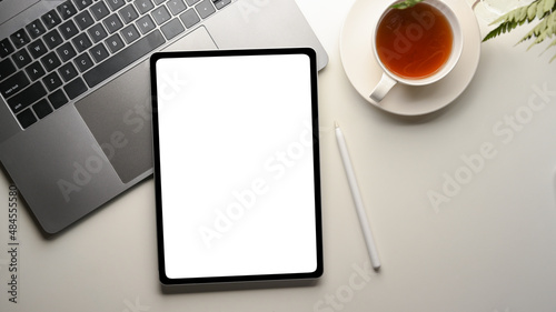 Top shot of a Modern office desk with digital tablet computer mockup