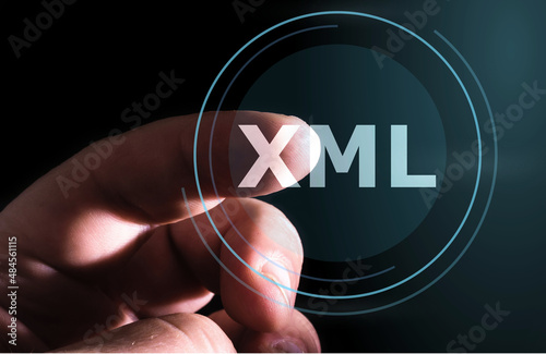 Hand pressing XML button on virtual screens. Extensible Markup Language
 photo