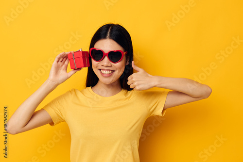 woman wearing sunglasses small gift box isolated background unaltered
