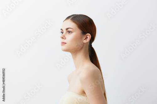 beautiful woman smiling woman bare shoulders clean skin charm light background