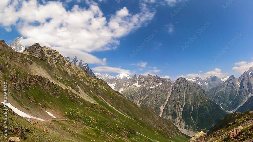 An amazing panoramic view on the mountain ridges near Mestia in the Greater Caucasus Mountain Range, Samegrelo-Upper Svaneti, Country of Georgia. The sharp peaks are covered in snow. Wanderlust