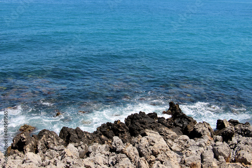 background of beautiful photography of the rocky coast of the clear blue sea