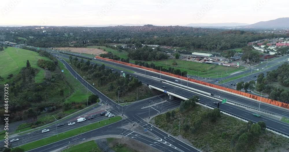 Hyperlapse aerial perspective of traffic building at traffic intersection with moving carriageway on arterial above. Hyperlapse aerial perspective of traffic building at traffic intersection with moving carriageway on arterial above.