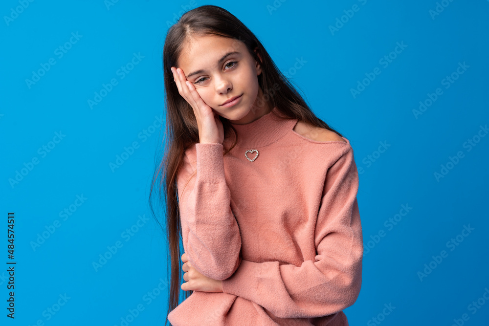 Portrait of cute emotional little girl facepalming on a blue background Portrait of cute emotional little girl facepalming on a blue background