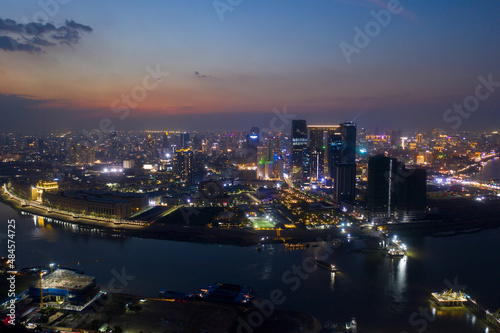Top View of Building in a City - Aerial view Skyscrapers flying by drone of Phnom Penh city with downtown , riverside and sunset © Nhut