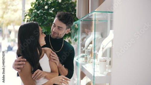 man and woman choosing jewelry in a boutique store