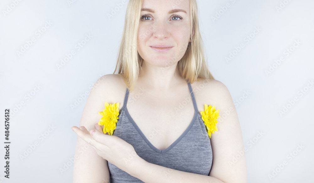 Concept of a pleasant smell from the armpits. Girl has yellow flowers sandwiched between her arms and chest. Body care. Women Health. Chrysanthemums. Bodypositive and struggle for female naturalness Concept of a pleasant smell from the armpits. Girl has yellow flowers sandwiched between her arms and chest. Body care. Women Health. Chrysanthemums. Bodypositive and struggle for female naturalness