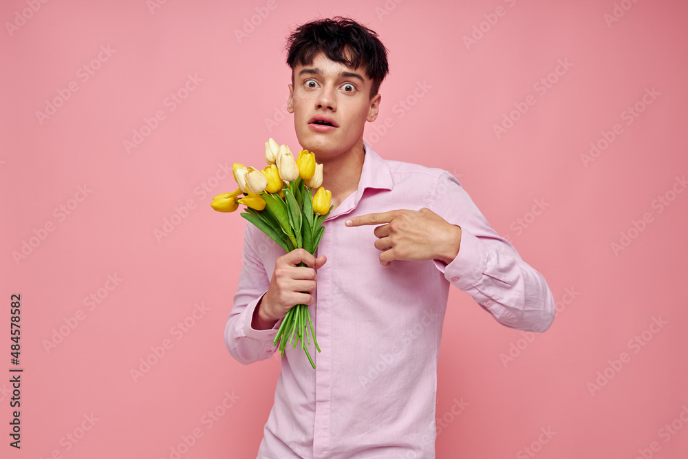 portrait of a young man bouquet of flowers date romance posing pink background unaltered portrait of a young man bouquet of flowers date romance posing pink background unaltered