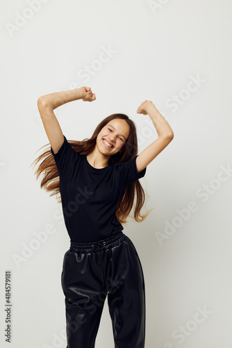 young beautiful woman in a black t-shirt hand gesture fun Lifestyle unaltered © Tatiana