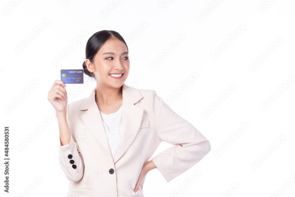 Portrait of a happy young asian woman wearing suit holding bank card, credit card isolated on white background. Business online shopping concept. Portrait of a happy young asian woman wearing suit holding bank card, credit card isolated on white background. Business online shopping concept.