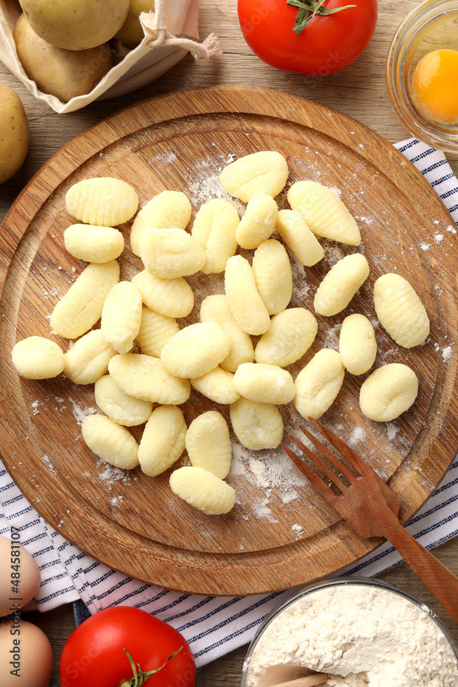 Concept of cooking with raw potato gnocchi, top view Concept of cooking with raw potato gnocchi, top view