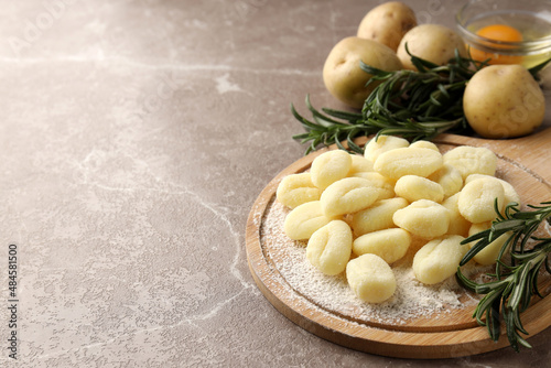 Concept of cooking potato gnocchi on gray textured background