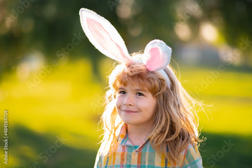 Bunny child boy face. Kids boy hunting easter eggs. Child in bunny ears hunt Easter eggs.