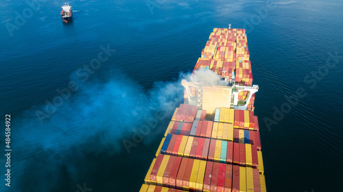 Stern of large cargo ship with Smoke exhaust gas emissions from cargo lagre ship ,Marine diesel enginse exhaust gas from combustion. forward mast photo