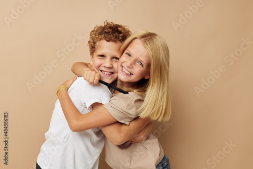Little boy and girl posing with a comb isolated background