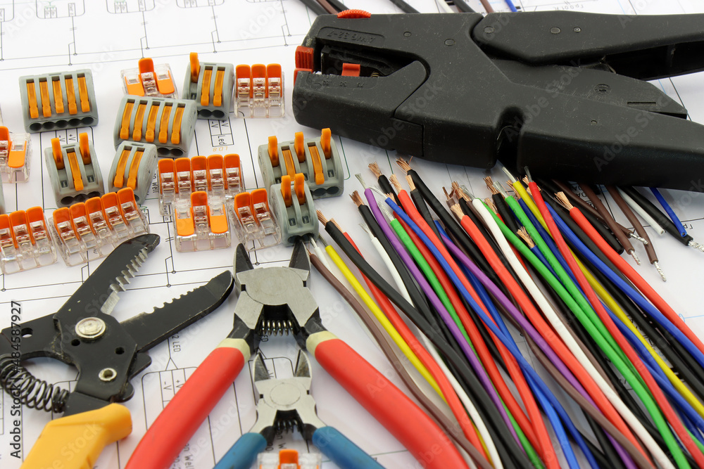 Colored mounting wires, terminals for quick connection of wires, mounting tools on the schematic diagram close-up.