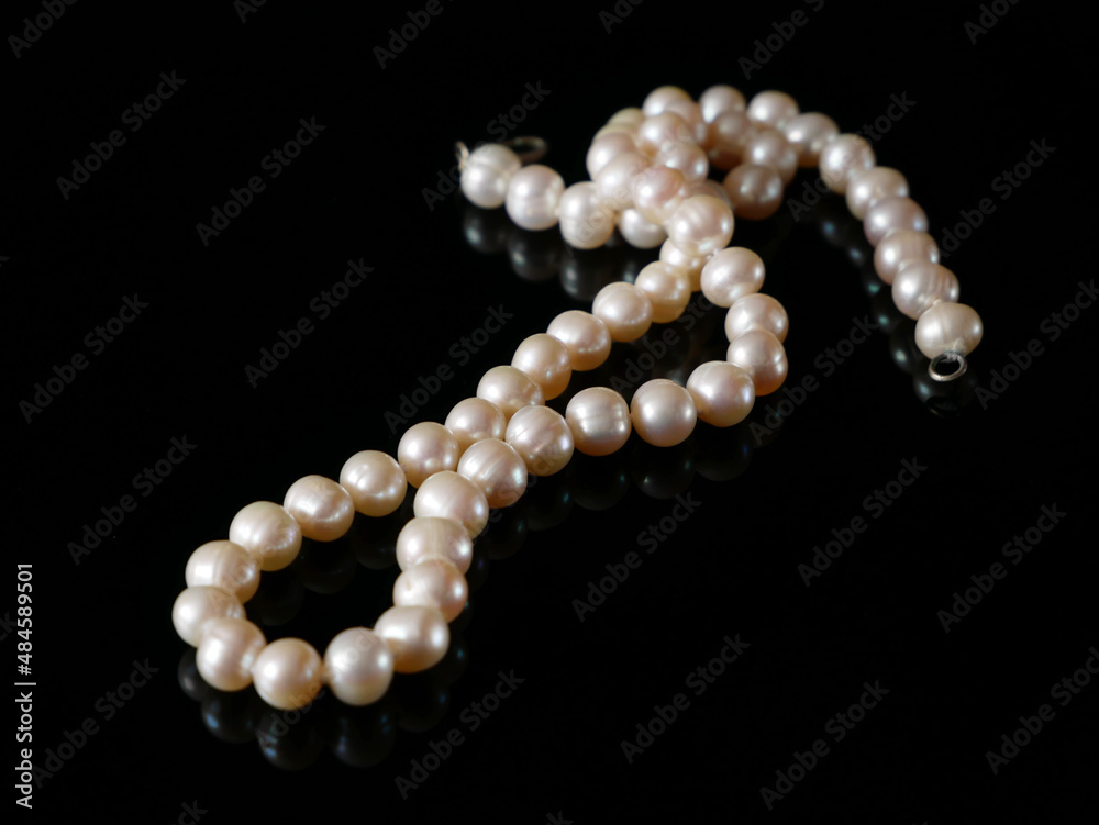 beautiful pearls necklace on black background, pawnshop concept, jewerly shop concept beautiful pearls necklace on black background, pawnshop concept, jewerly shop concept