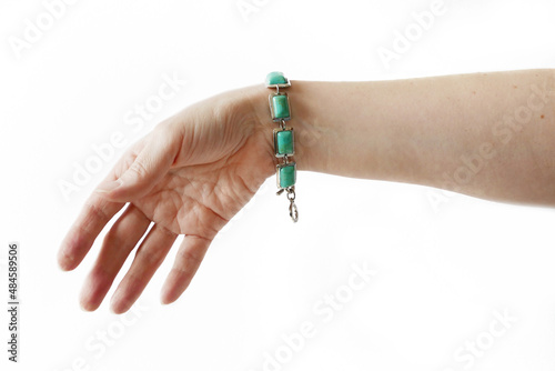 Woman hand wearing vintage silver bracelet with green stones isolated on white background, mock up design