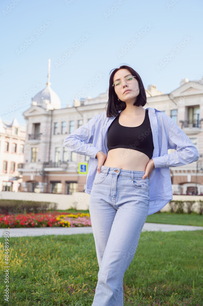 Portrait of beautiful young woman in city park.