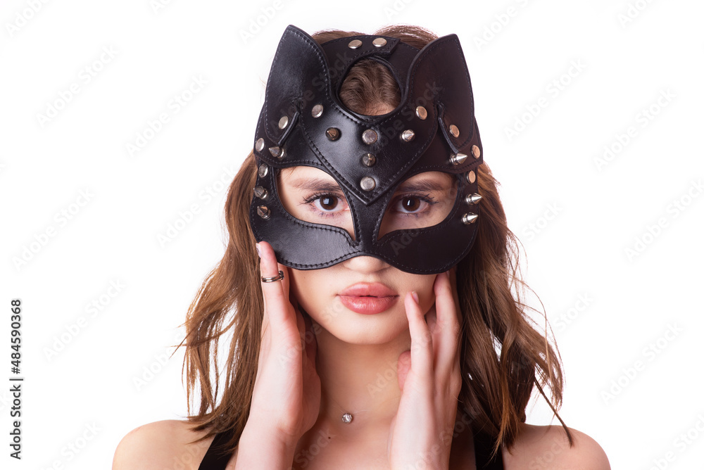 Leather, elegant, black mask of the cat on young female model on white background. isolate. close-up, portrait