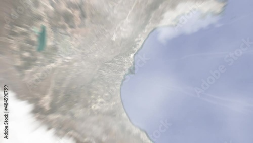 Earth zoom in from outer space to city. Zooming on Comodoro Rivadavia, Argentina. The animation continues by zoom out through clouds and atmosphere into space.  Images from NASA photo