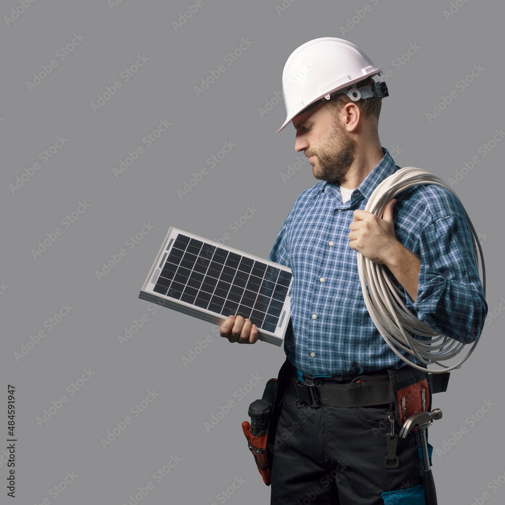 Electrical engineer holding a solar panel Electrical engineer holding a solar panel