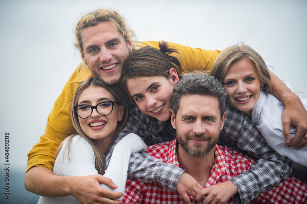 Group of happy people. Youth and friendship concept. Group of friends laughing outdoor, sharing good and positive mood.