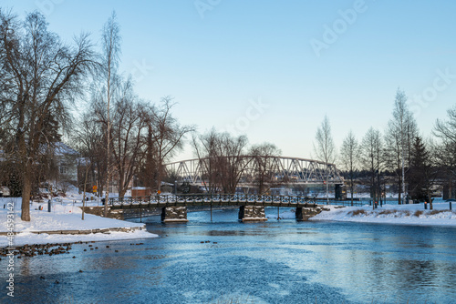 View to The Lake Saimaa and bridge to The Olavinlinna Castle from the shore in winter, Savonlinna, Finland