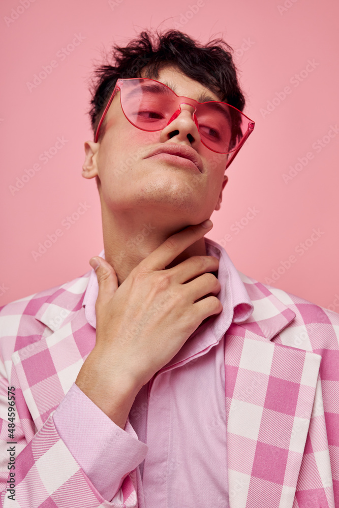 Obraz premium portrait of a young man fashionable pink sunglasses jacket posing pink background unaltered